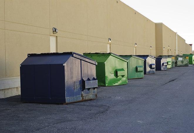 a crowd of dumpsters of all colors and sizes at a construction site in Ashwaubenon